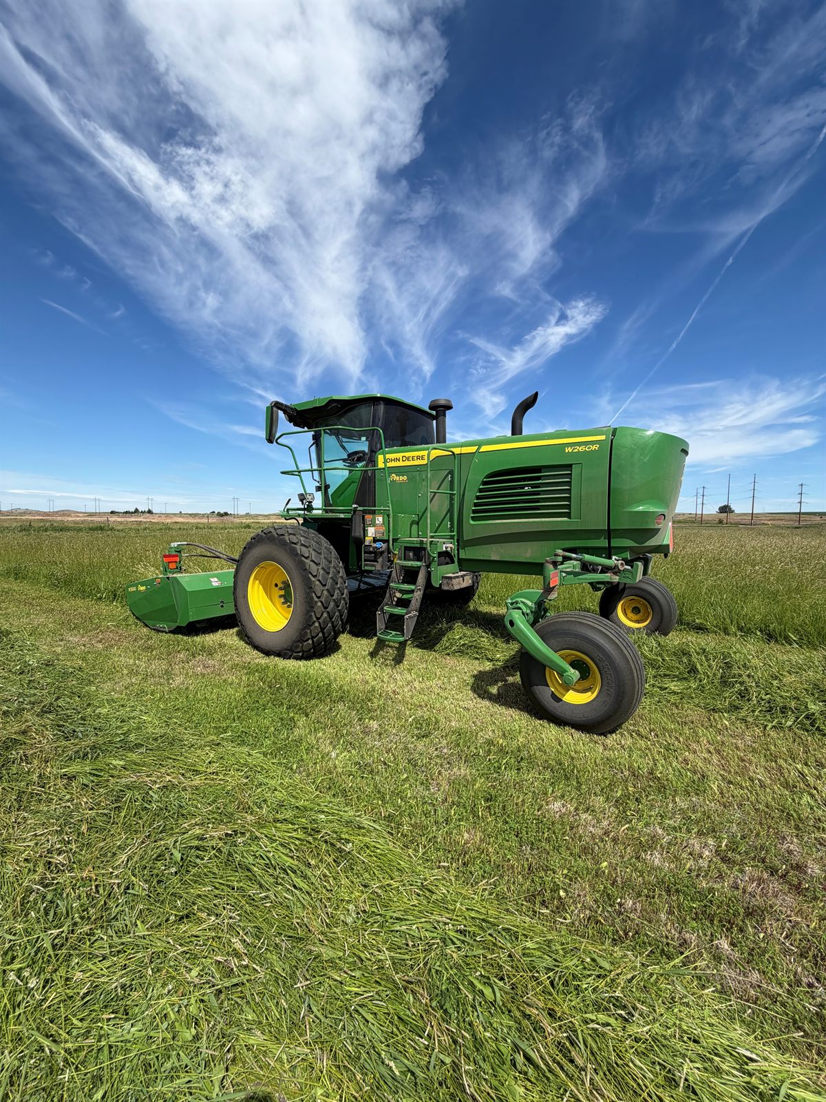 John Deere W260R swather windrowing the first cutting